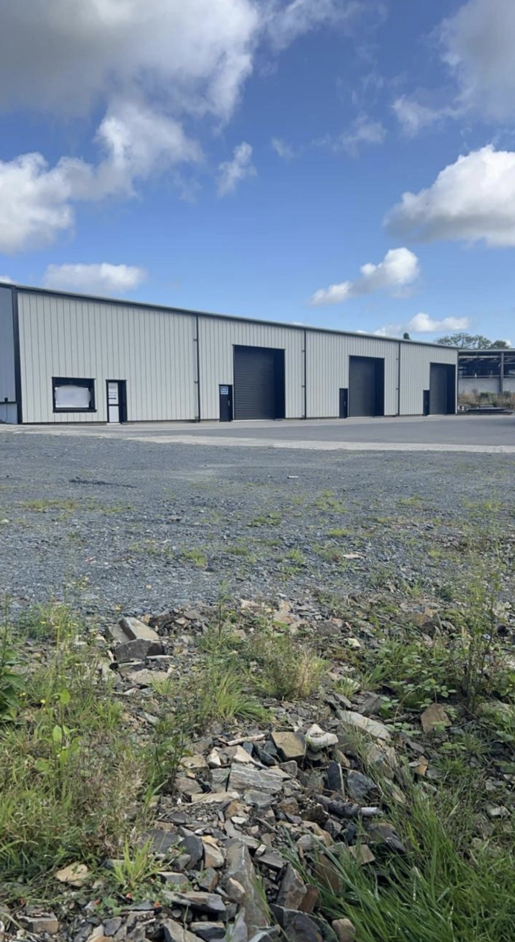 Grey steel industrial units with multiple roller doors